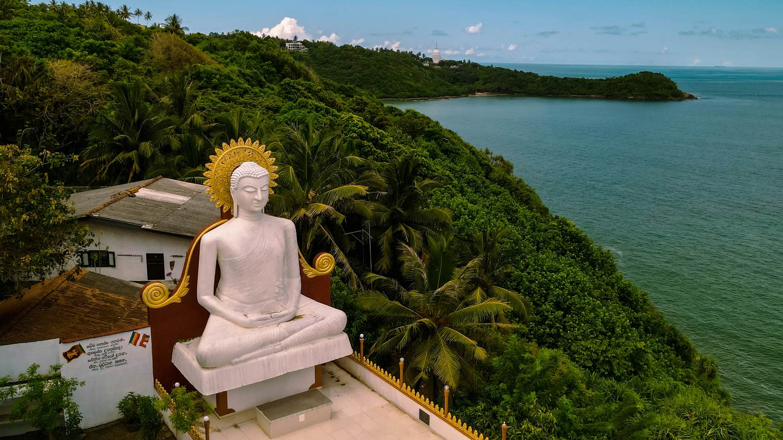 Large seated Buddha statue overlooking the coast