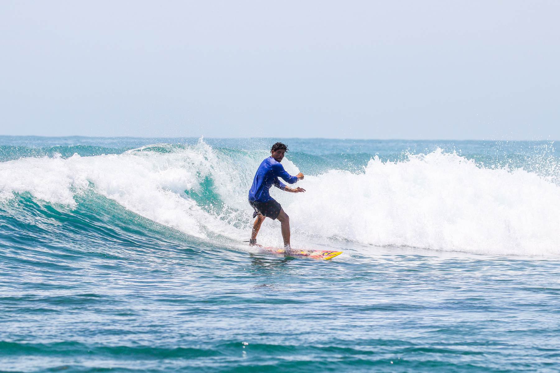 Surfer riding a wave off the Sri Lankan coast