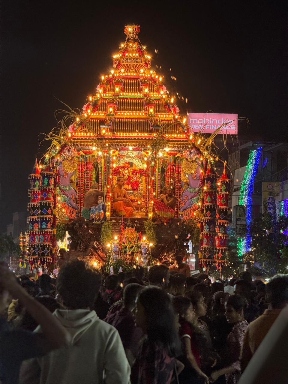 An illuminated temple chariot at a night festival